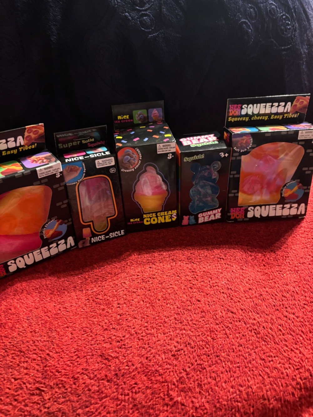 5-Squishy Multicolor 2- Nee-DOH Squeezza, 1-ice Cream, 1- Gummy Bear, 1 sicyle .
